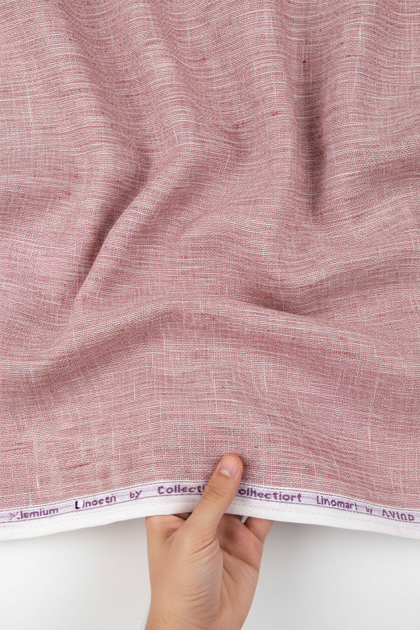 Light coral Arvind Tresca Linen plain shirting fabric roll with visible texture and soft drape, ideal for stylish clothing projects.