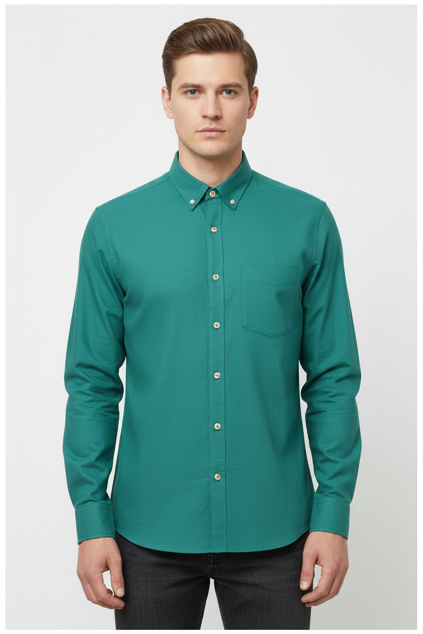 Teal green cotton shirt fabric by Arvind, showcasing a close-up of the textured textile with detailed weave pattern.