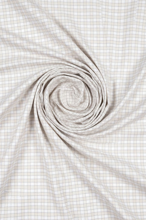 Beige Tresca cotton checks shirting fabric by Arvind, showcasing a close-up of the textured check pattern and fabric weave.