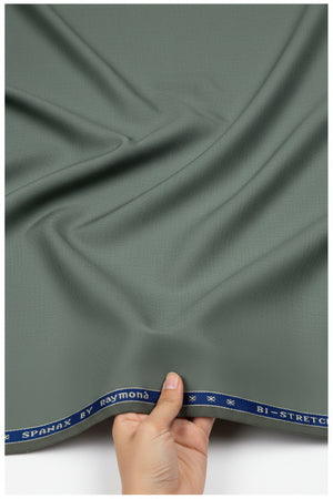 Raymond Polywool trousers and suiting fabric in laurel green with Lycra stretch, shown in close-up detail.