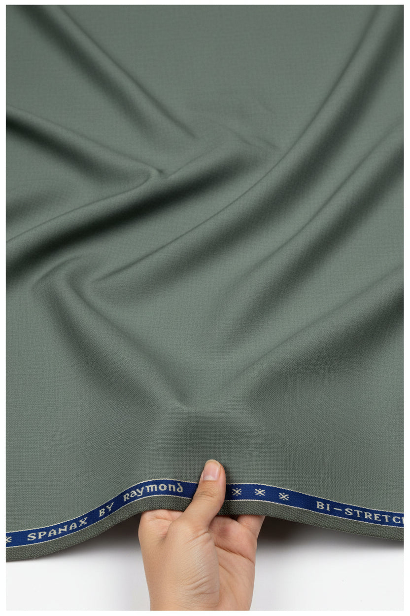 Raymond Polywool trousers and suiting fabric in laurel green with Lycra stretch, shown in close-up detail.