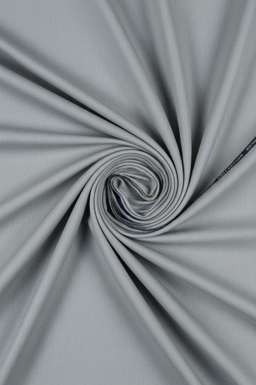 Gray Raymond Polywool fabric for trousers and suiting, showing a close-up of the luxurious unstitched textile material.
