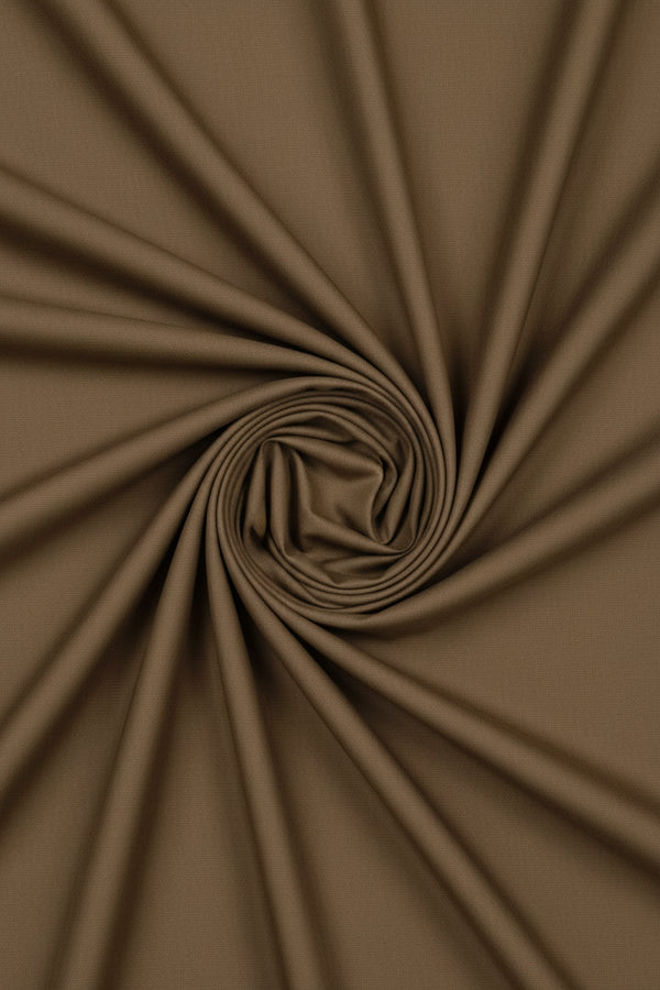 Wood brown Arvind cotton lycra stretchable suiting fabric, close-up of smooth, woven textile with slight stretch and soft texture.