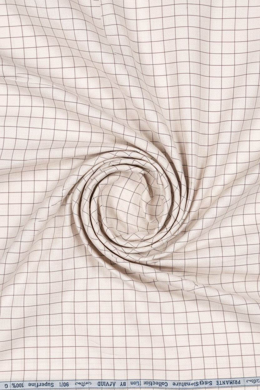 Beige Arvind cotton shirting fabric with a smooth texture, suitable for shirts and tailored clothing designs.