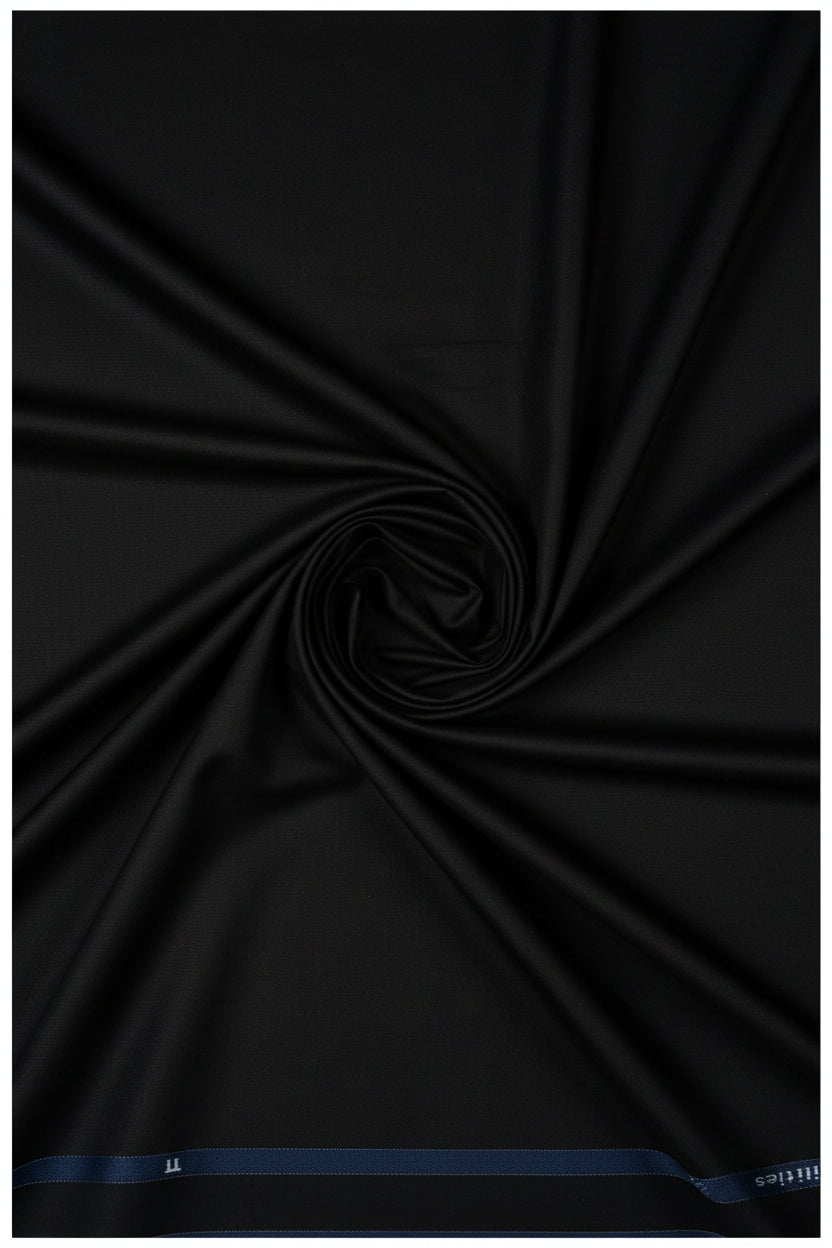 Black Arvind cotton lycra stretchable trouser and suiting fabric, showing smooth fabric with a slight sheen and flexible texture.