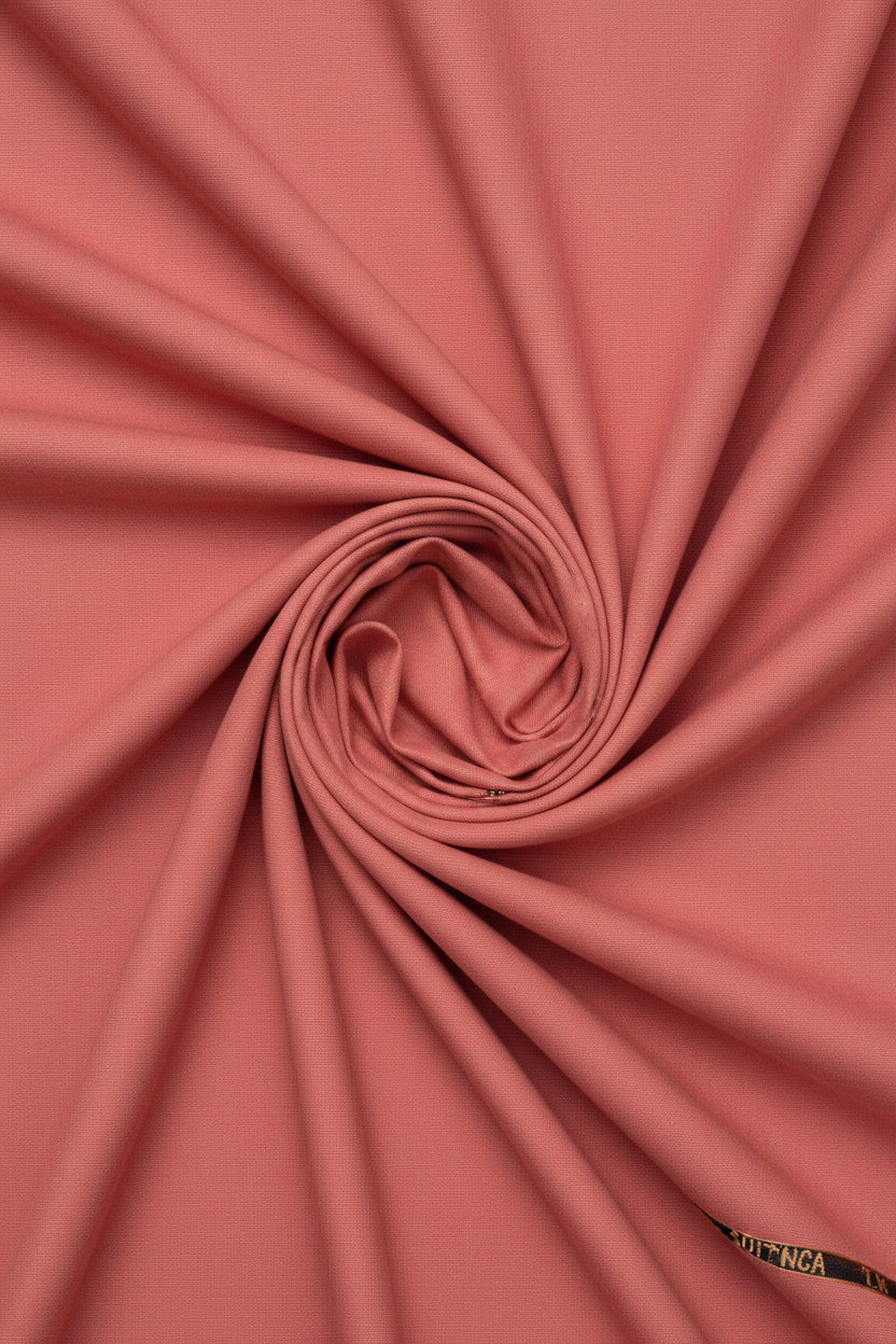 Carrot red Arvind poly viscose trousers and suiting fabric, showing fabric texture and color for tailored clothing.