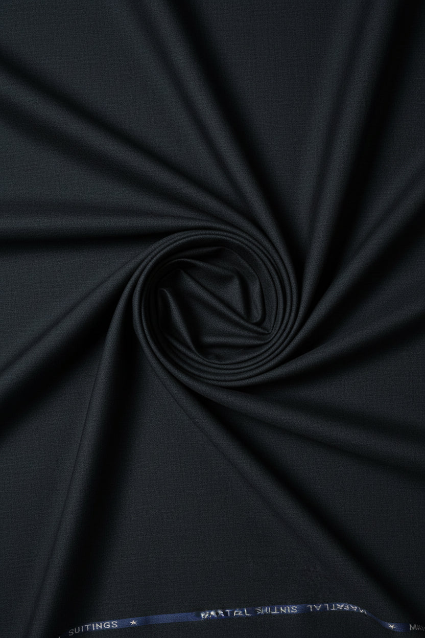 Charcoal grey Mafatlal unstitched poly viscose trouser and suiting fabric laid flat, showing the soft, smooth textile texture.