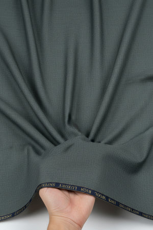Dark grey Georgia Gullini of Italy Super 150’s Polywool trousers fabric, close-up view of textured woven material.