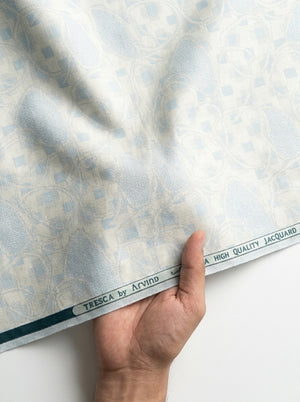 Golden Arvind Tresca cotton jacquard unstitched shirting fabric displayed in a handheld image.