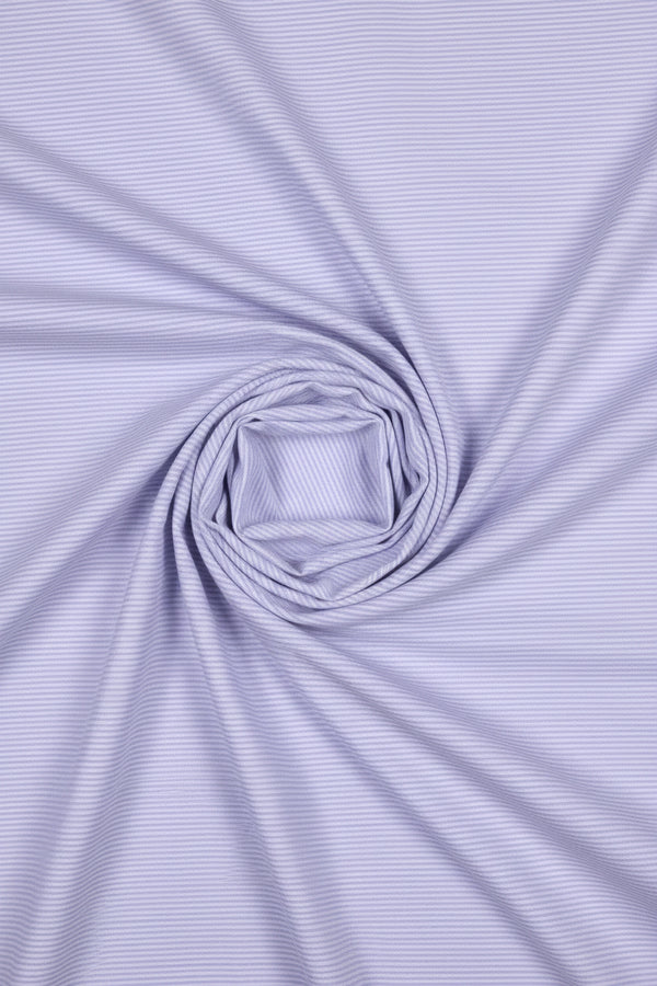 Close-up of a textured purple fabric with horizontal lines