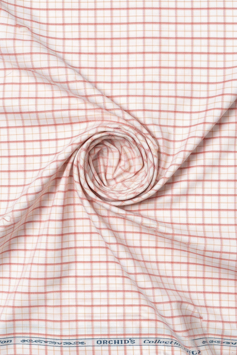 Carrot orange Arvind Checks cotton shirting fabric displaying a vibrant checkered pattern suitable for shirts.