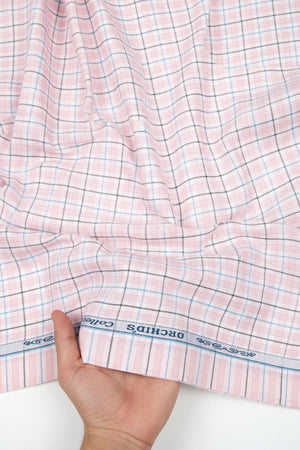 Light pink Arvind Checks cotton shirting fabric with a checkered pattern, showcasing soft texture and fine weave.