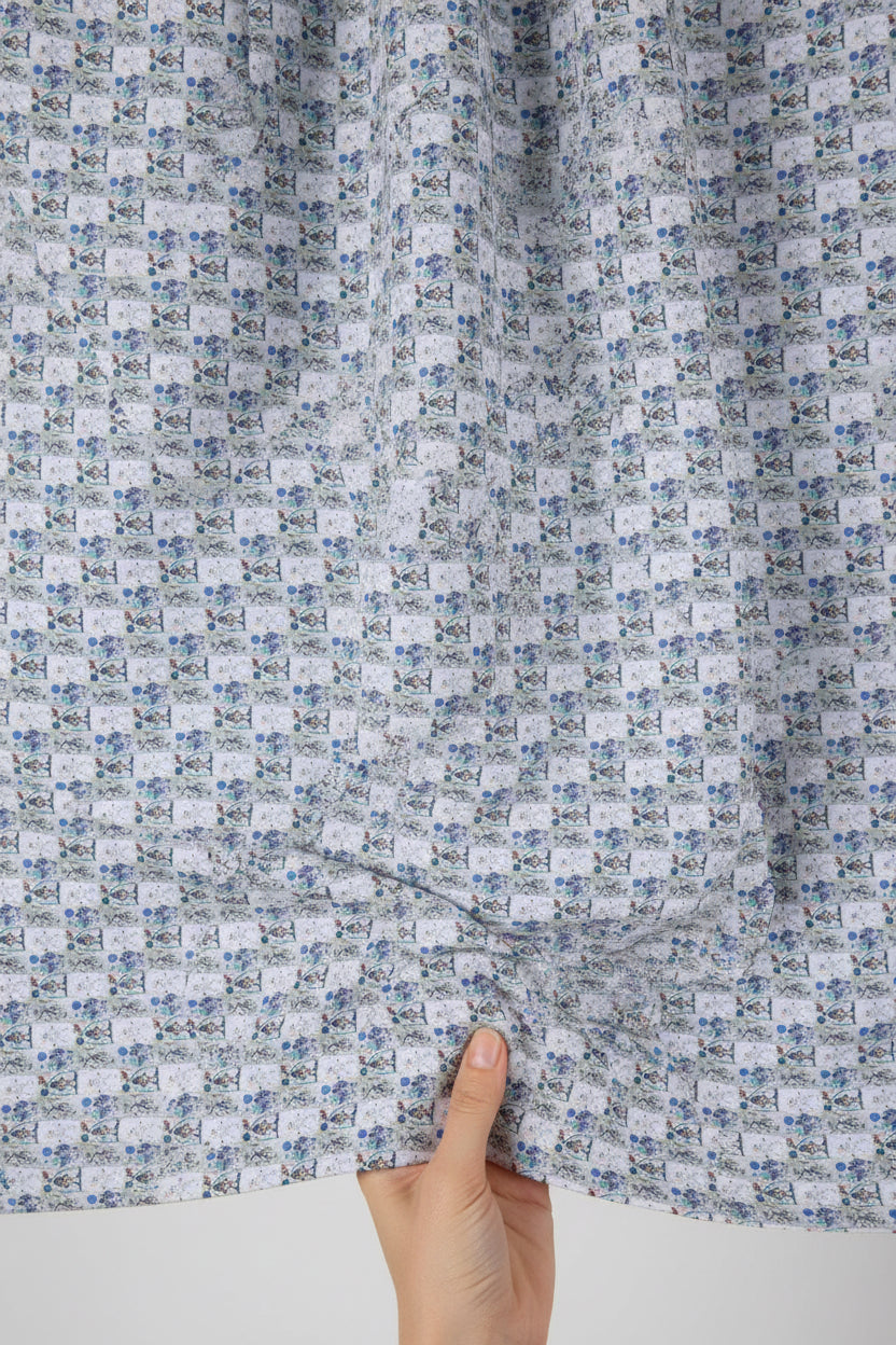 Patterned fabric with small images of people and nature on a blue and green background