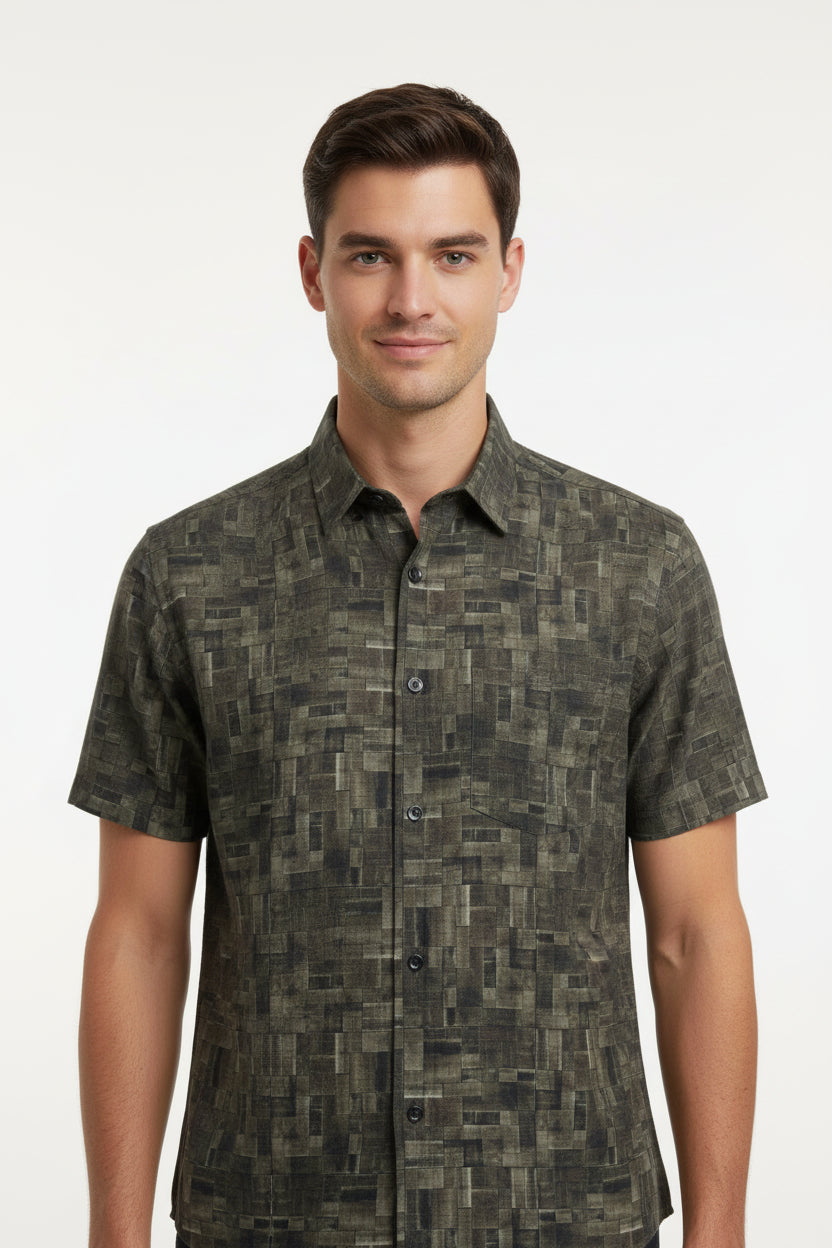 Olive green Pee Gee cotton shirt fabric with digital print pattern, close-up of the textured textile and vibrant design details.