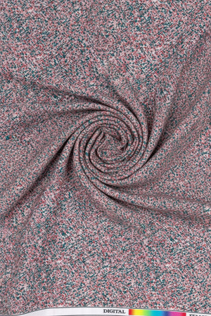 Close-up of a speckled pink and gray material with a color swatch at the top.