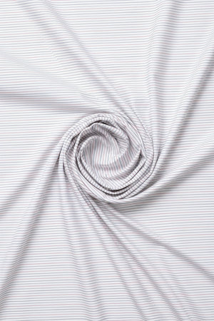 White striped shirting fabric by ARVIND, showing a close-up of the textured cotton material with blue and white stripes.