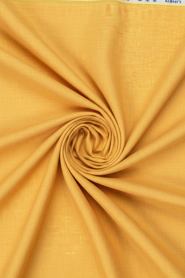 Arvind pure linen shirt fabric in amber yellow, unstitched material with a soft, breathable texture suitable for custom tailoring.