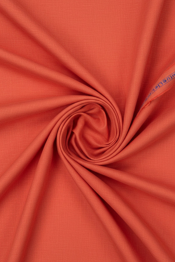 Plain Arvind linen shirting fabric in reef orange, showing a smooth, lightweight textile suitable for shirts and summer wear.