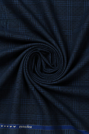 Raymond navy blue checked poly wool fabric for trousers and suits, showing a close-up of the luxurious unstitched material.