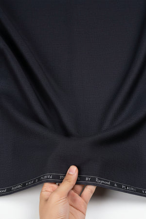 Purple Raymond Polyviscose fabric for trousers and suiting, shown in a close-up image highlighting the textured textile.
