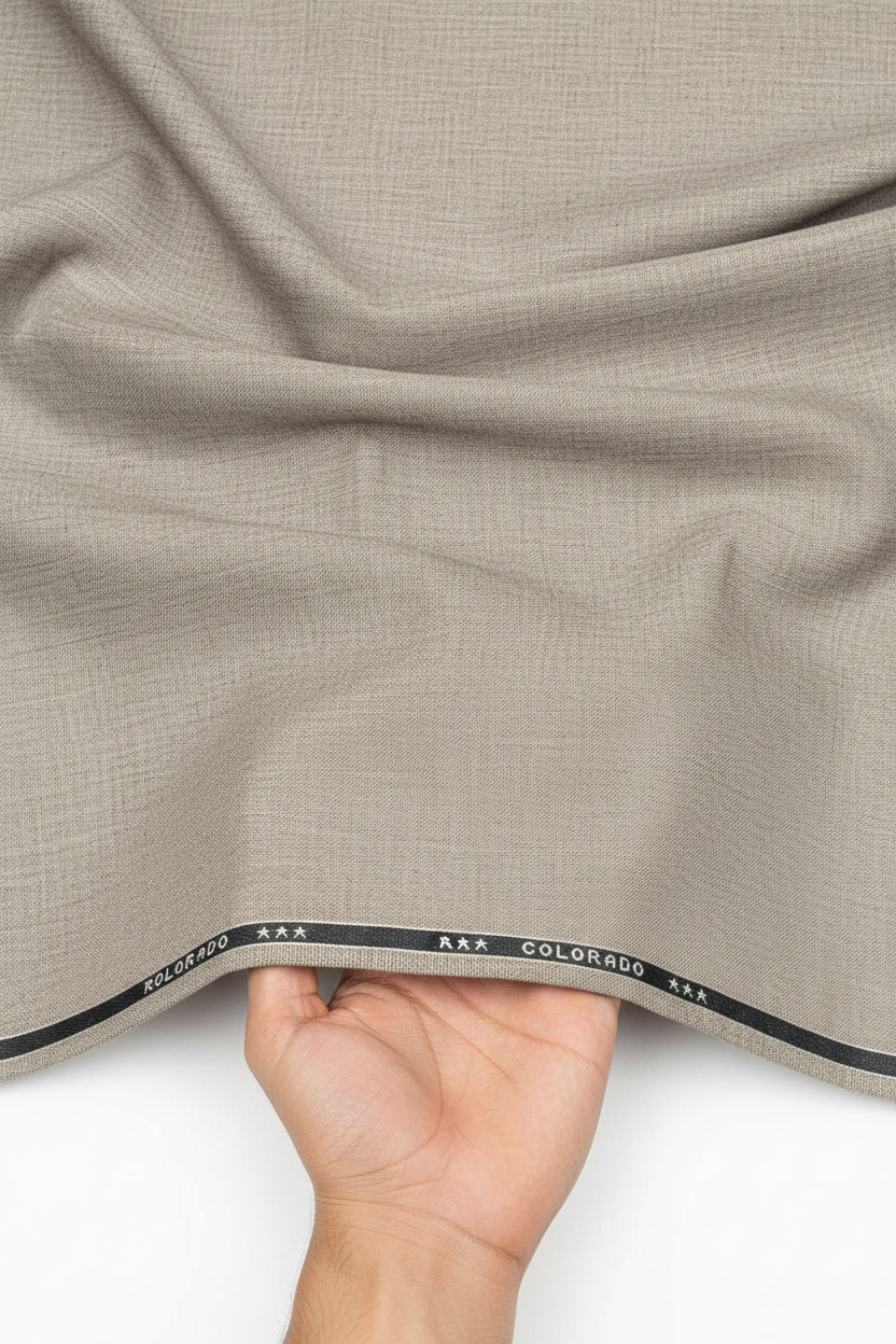 Beige Raymond unstitched TR trouser and suiting fabric, luxurious textile for custom tailoring, shown in a close-up image.