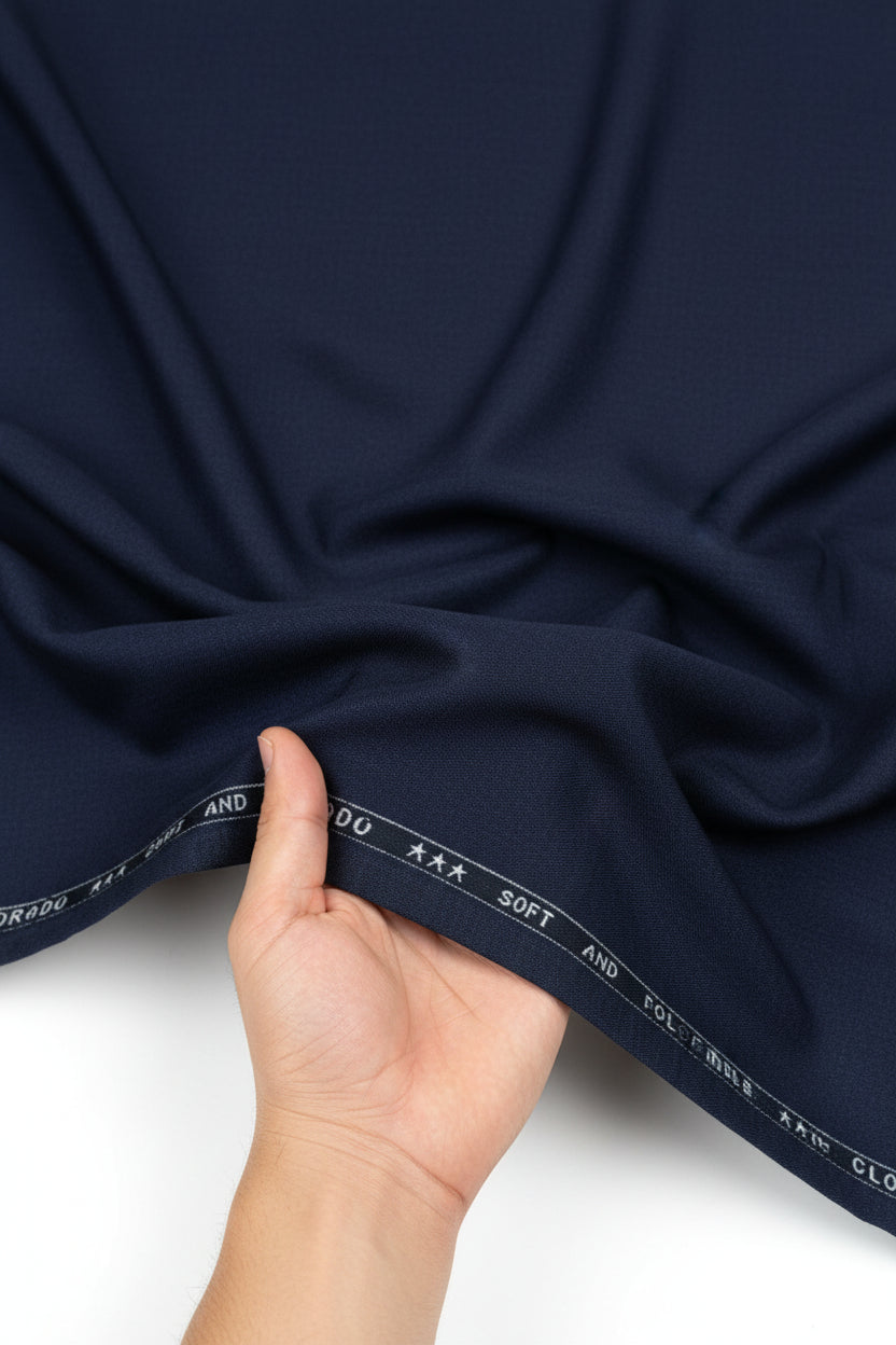 Navy blue Raymond Terry rayon trousers and suiting fabric, smooth textured fabric with a tailored appearance.