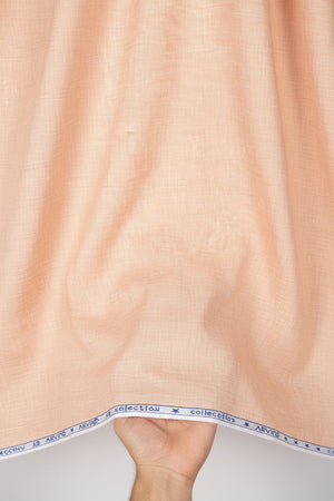 Plain beige Arvind linen shirt fabric in unstitched material, shown in a close-up view with fabric texture and folds.