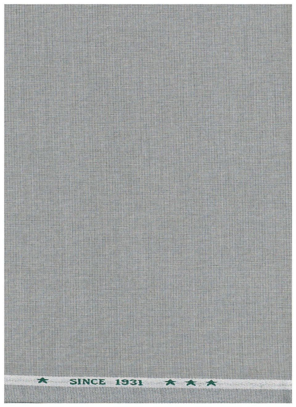 A close-up of a light gray woven fabric texture with a narrow white header band at the top featuring small green decorative marks and the text 'SINCE 1931'.