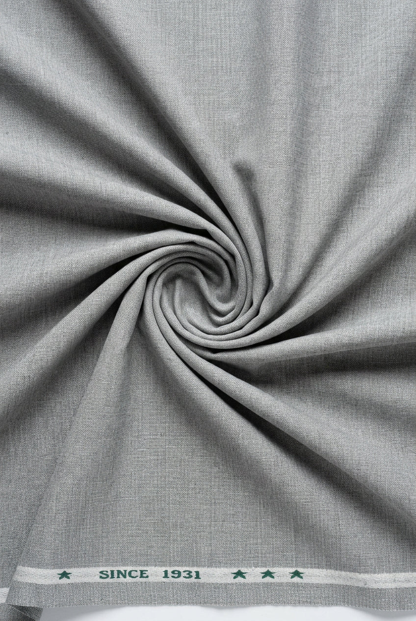 Light grey Arvind Lycra stretchable suiting fabric showing smooth, flexible textile with subtle texture for tailored garments.