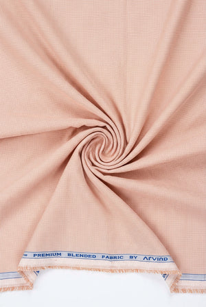Light peach Arvind Signature cotton polycot shirt fabric with a smooth texture and subtle pattern, ideal for stylish shirts.