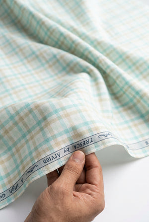 Green checkered arvind giza cotton shirt fabric with white checks, showcasing high-quality textile design.
