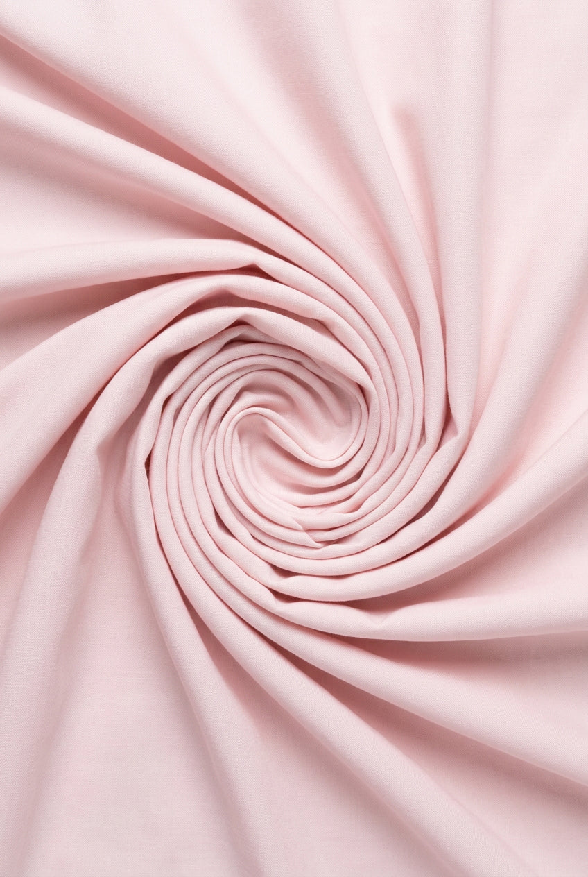 Light pink cotton shirting fabric from Mensfabric, showcasing a smooth, high-quality textile ideal for men's shirts.