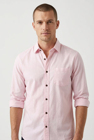 A light pink cotton fabric sheet with visible wrinkles, showing a blue printed edge with 'COTTON' text at the bottom.