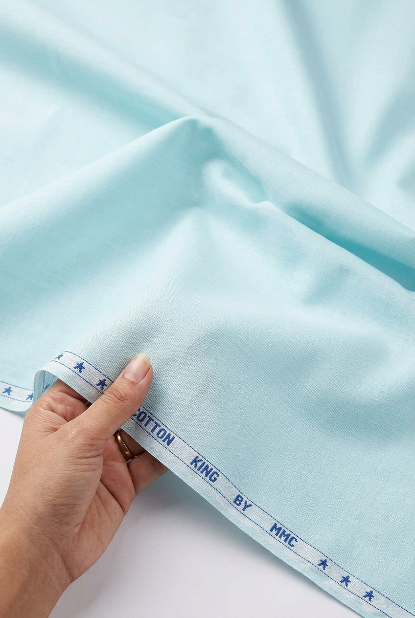Aqua blue cotton shirting fabric from Mensfabric, showing smooth, lightweight Italian cotton material with a subtle texture.