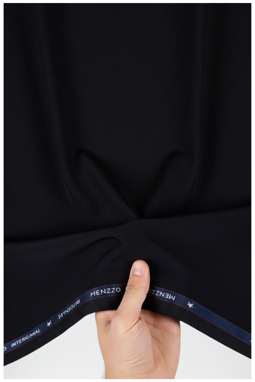 Black Mafatlal poly viscose trousers and suiting fabric, showing fabric texture and tailored fit details.